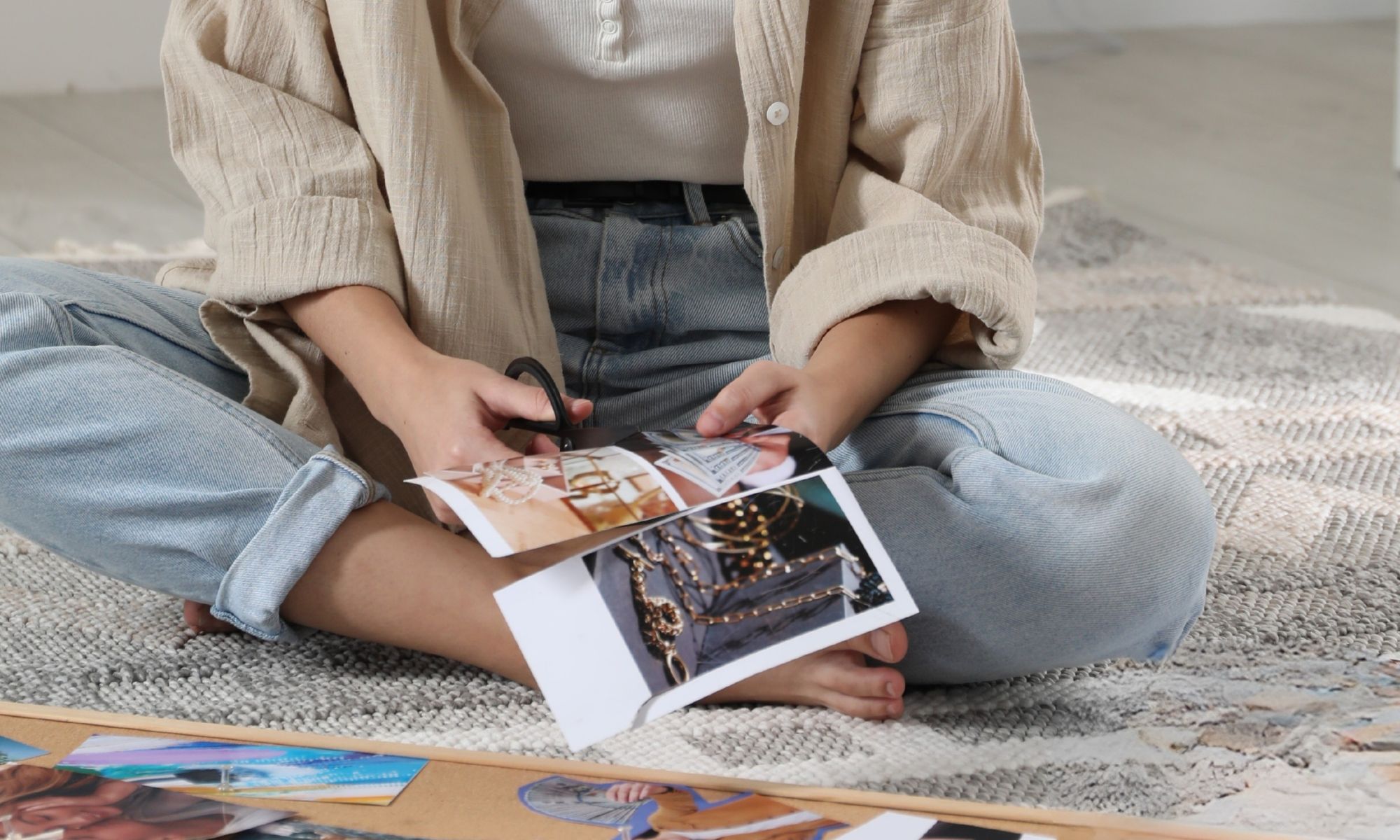 woman cutting magazine images to create a fashion vision board